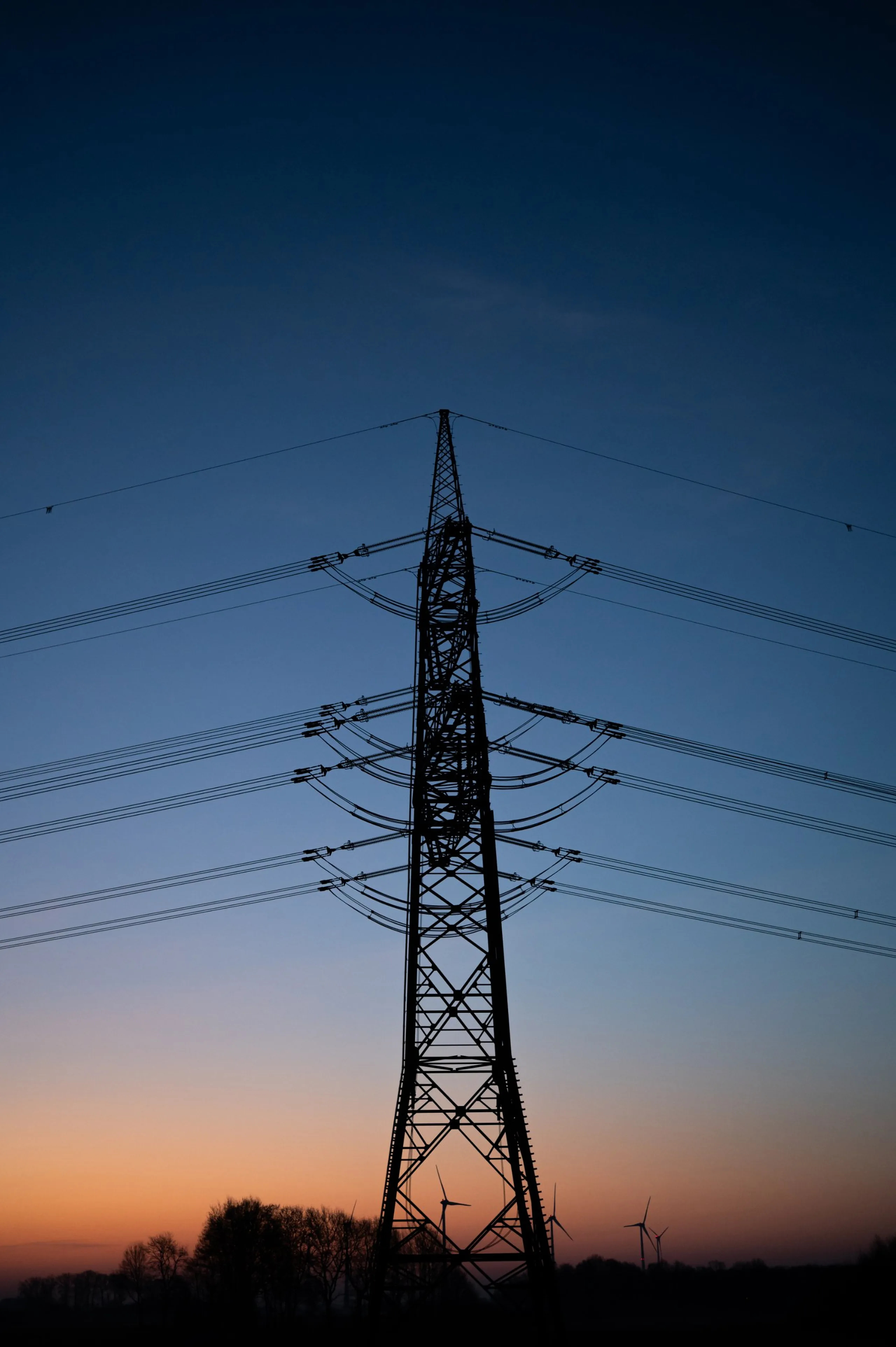 High-voltage transmission tower against the sky at dawn